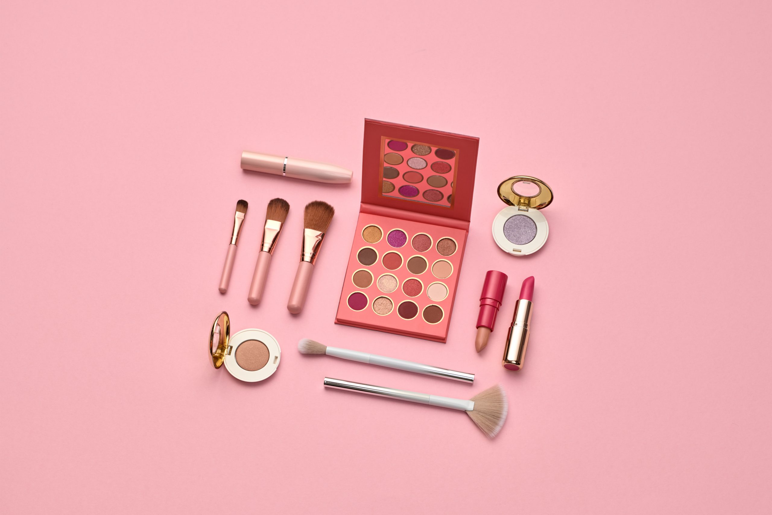 Fashion beauty product layout. Woman Essentials cosmetic makeup Set. Collection beauty accessories background. Trendy Brushes, art Design pastel Flat lay. Creative cosmetics shopping concept on pink